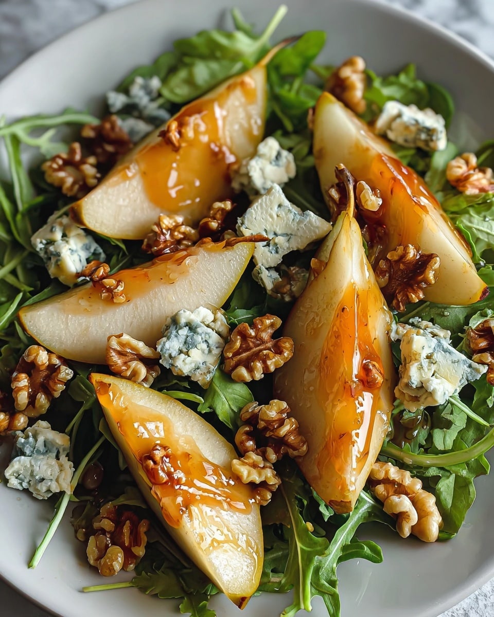 The dish is a fresh salad served in a white plate placed on a white marbled texture. The base layer consists of green arugula leaves spread evenly across the plate. On top of this bed of greens, there are several golden-yellow pear slices arranged in a slightly overlapping fashion. Scattered among the pear slices are small chunks of white and blue-veined blue cheese, offering a crumbly texture. The salad is topped with crunchy, brown caramelized walnuts, adding a shiny glaze to the dish. The overall look is colorful with earthy tones and textures, with a light drizzle of a glossy dressing over the pear slices and walnuts. photo taken with an iphone --ar 4:5 --v 7