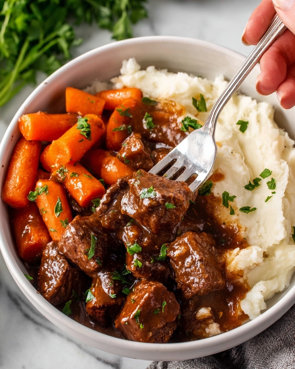 A white bowl filled with three layers: on the left, bright orange glazed baby carrots sprinkled with small green parsley pieces; on the right, creamy white mashed potatoes forming the base layer; on top of the mashed potatoes, dark brown beef stew chunks coated in a glossy rich gravy with small green parsley leaves scattered over. A silver fork held by a woman's hand lifts a piece of beef covered in gravy in the center. The bowl is set on a white marbled surface with some green herbs blurred in the background. Photo taken with an iphone --ar 4:5 --v 7