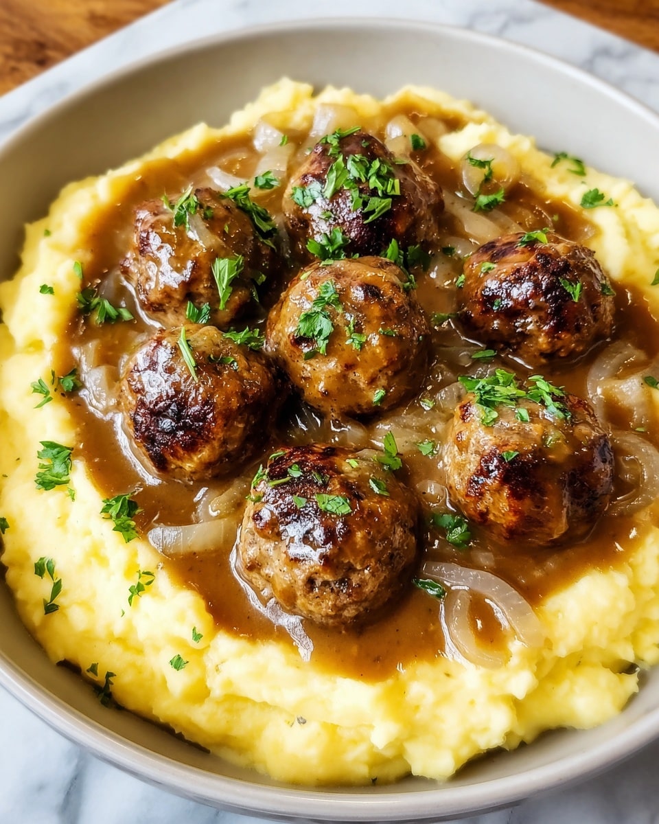 A bowl with a base layer of creamy yellow mashed potatoes, topped with a layer of thick brown gravy spread over the potatoes. On top, there are seven browned meatballs arranged closely together, each coated with the same brown gravy. The meatballs have some charred spots and are garnished with small white onion slices and bright green chopped parsley sprinkled evenly over the dish. The bowl is white and placed on a white marbled surface. Photo taken with an iphone --ar 4:5 --v 7